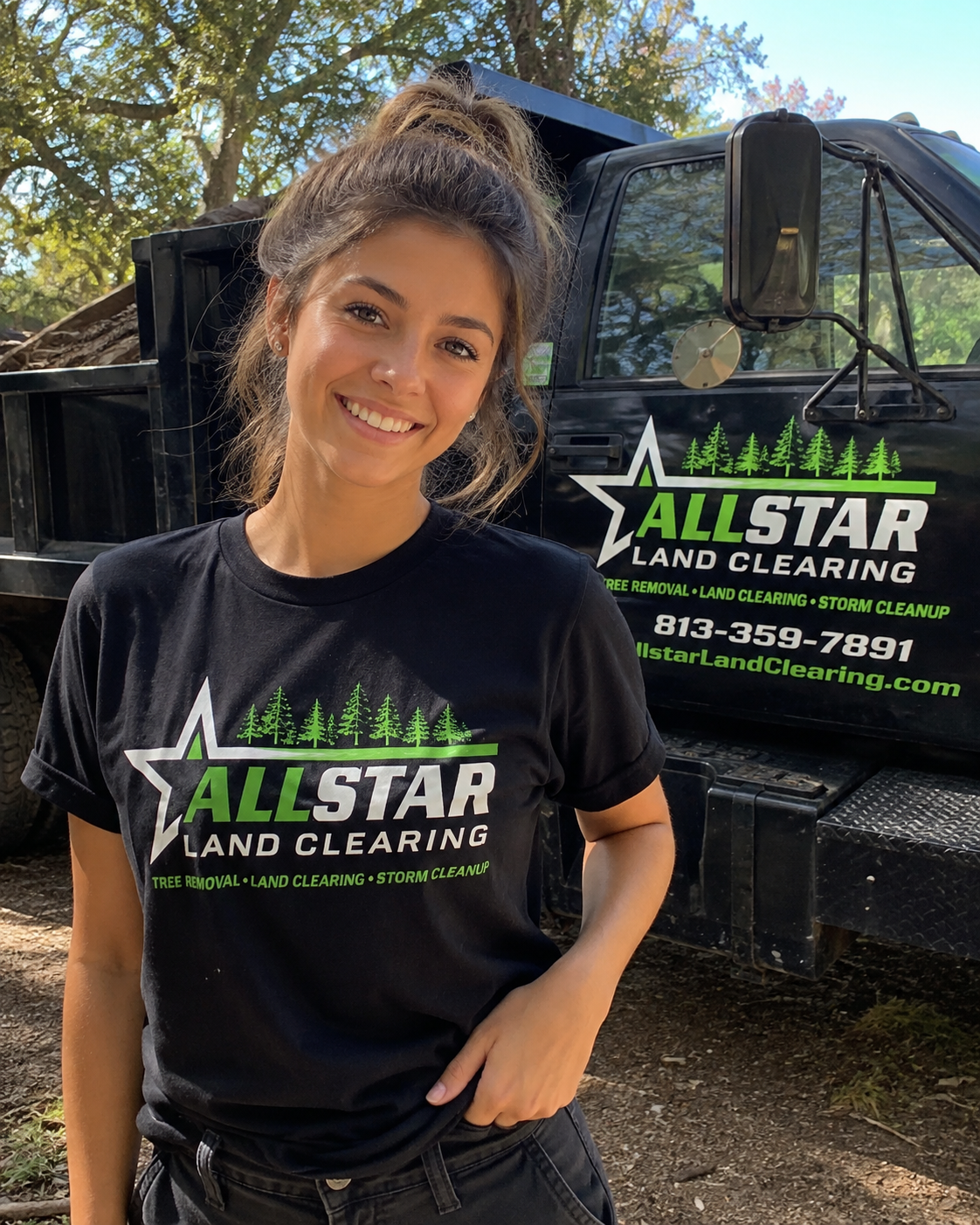 AllStar Land Clearing team member standing in front of a branded dump truck